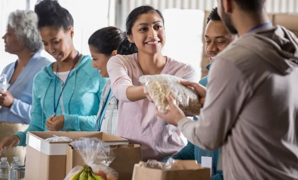Volunteers organizing supplies at a food bank distribution