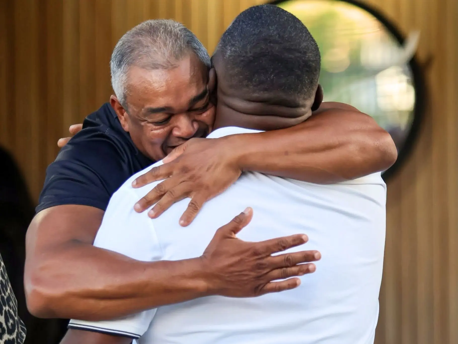Two men embracing at the entrance of a church